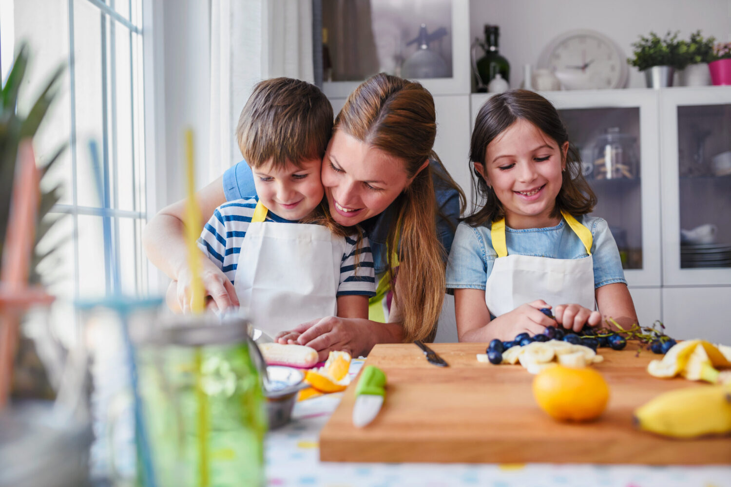 Mom cooking with her two kids