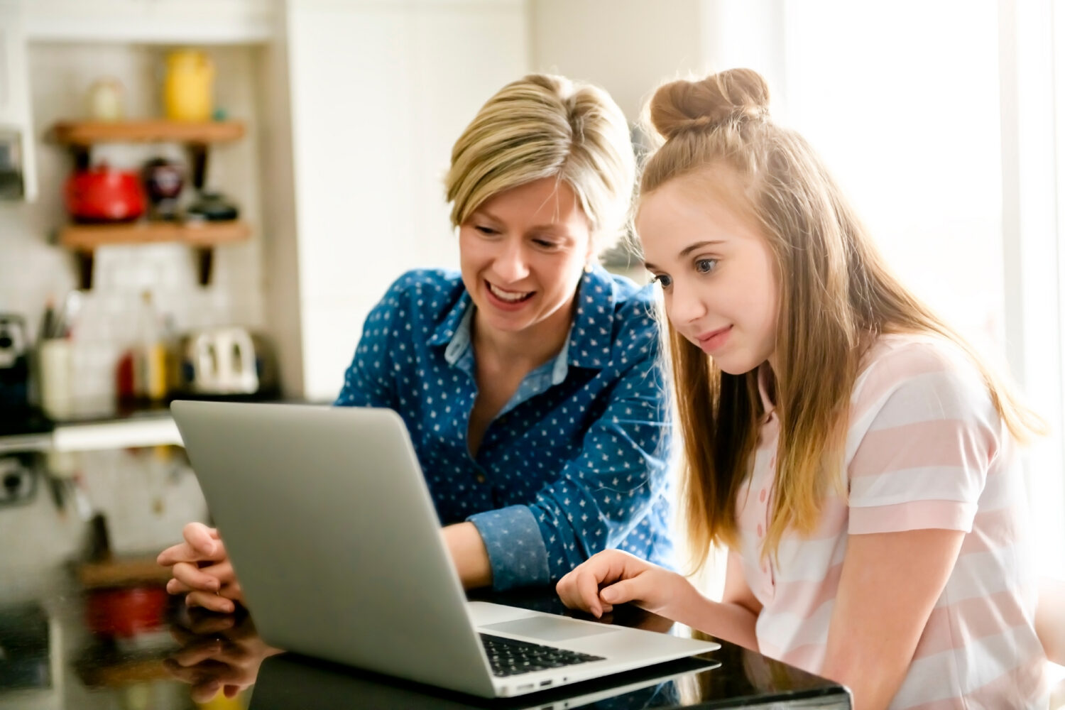 Mom and daughter on a computer