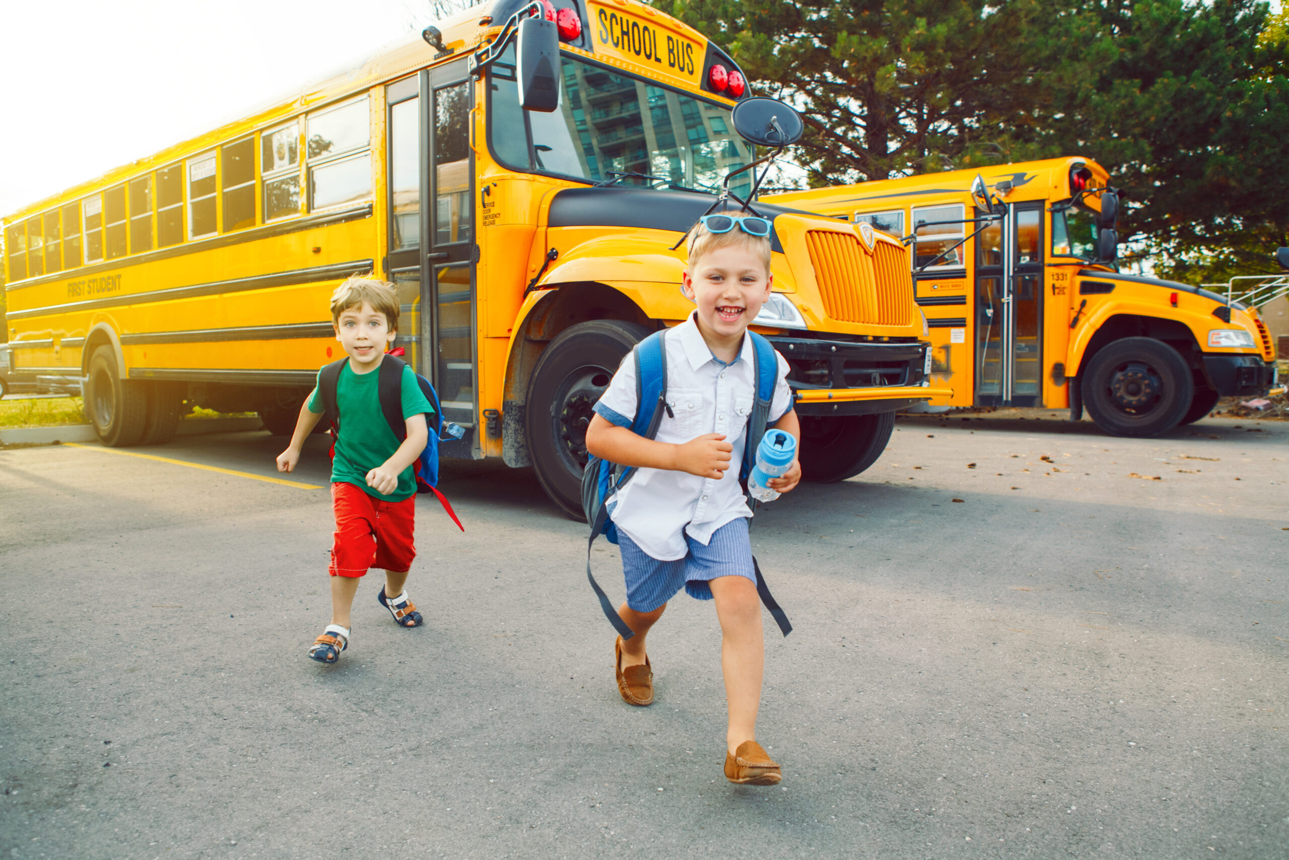 two boys getting off a school bus