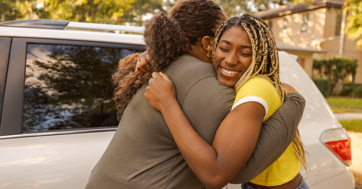 Mom and teenage daughter hugging