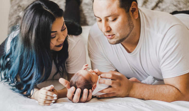 mom and dad with newborn baby