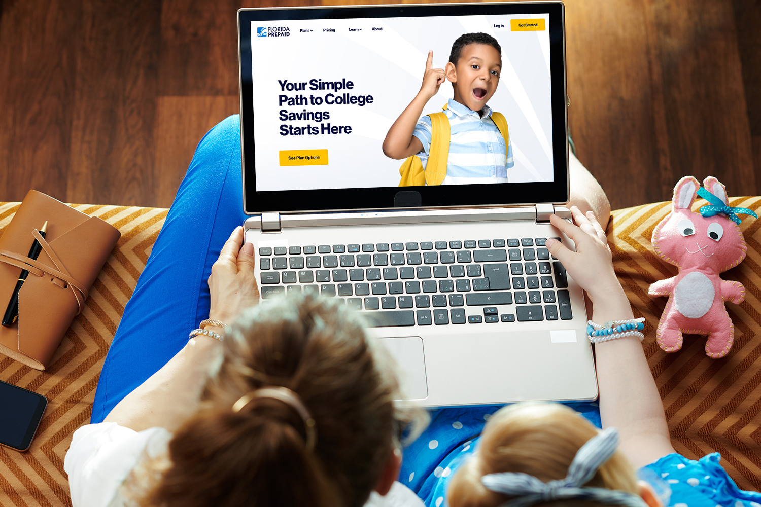 Mom and daughter looking at the new Florida Prepaid website on a laptop