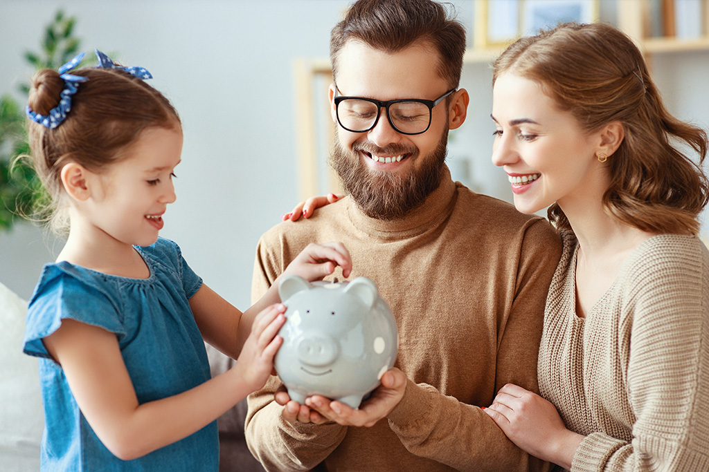 Family using piggy bank to save