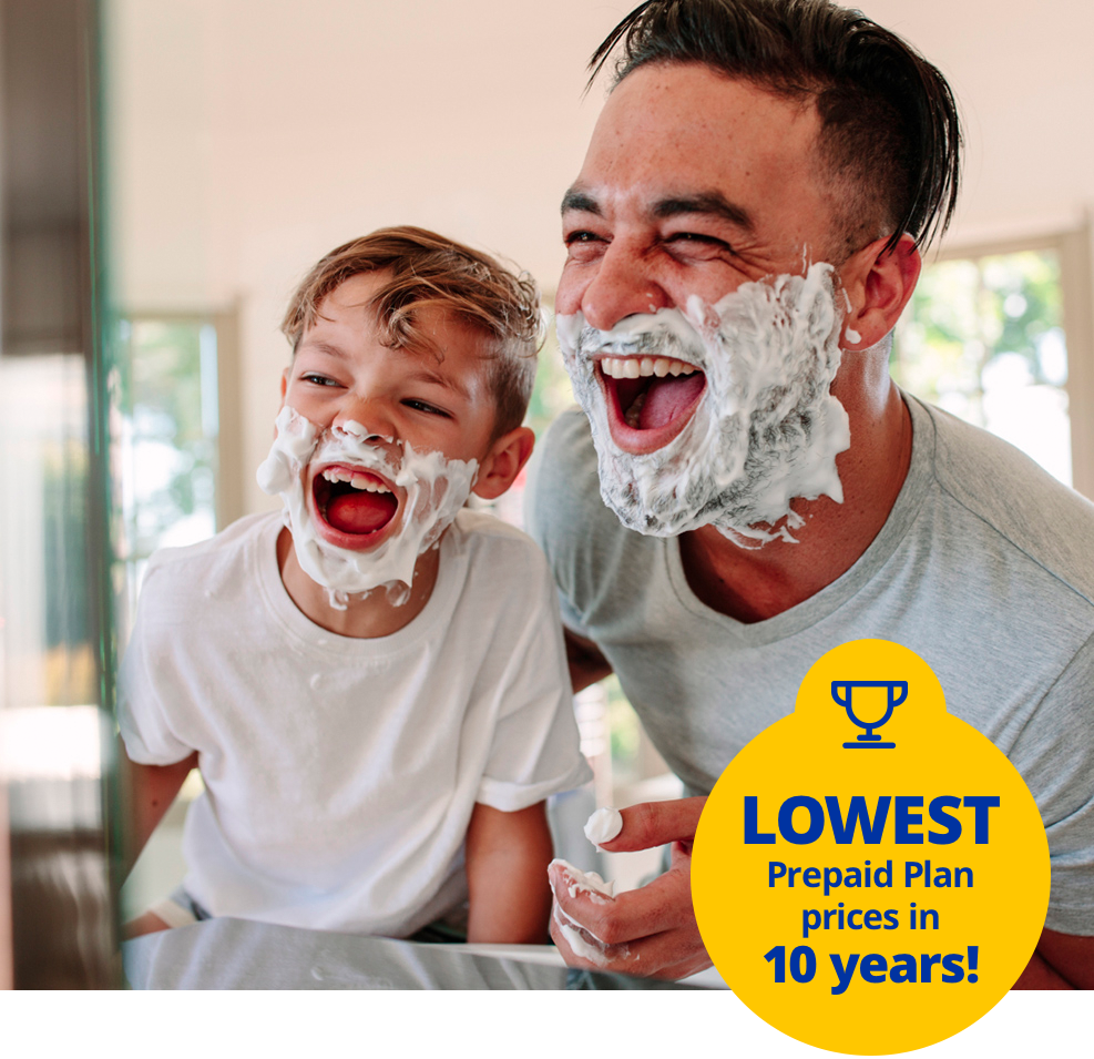 Father and son having fun learning to shave