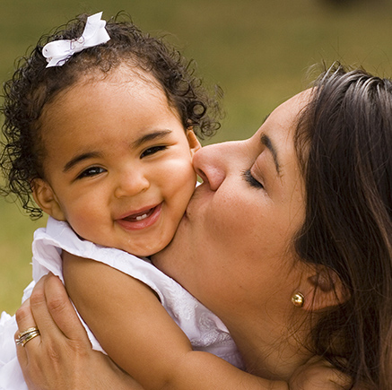 mom kissing baby