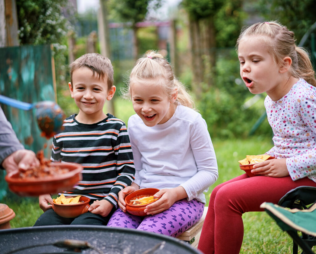 excited kids outside eating chips and salsa