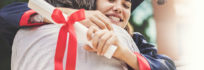 Happy college graduate hugging her father